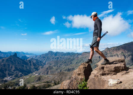 Gran Canaria, Canary Islands, Spain 16th January 2019. Weather: A Trail runner looks out over the central crater high in the mountains of Gran Canaria as some of the world`s elite ultramarathon/trail runners start arriving on the island to prepare for the gruelling 125km Ultra World Tour series TransGranCanaria mountain race which takes place in February. Credit: ALAN DAWSON/Alamy Live News Stock Photo
